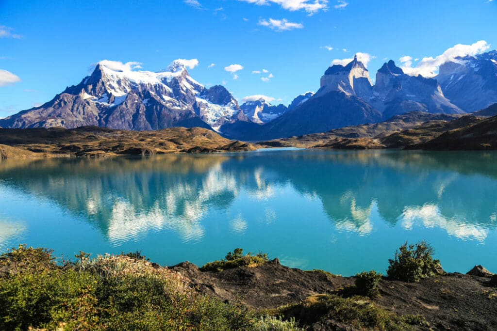 Hidden Places Around the World,Mountainous landscape in the Aysen region of Chile with a turquoise lake reflecting the peaks.