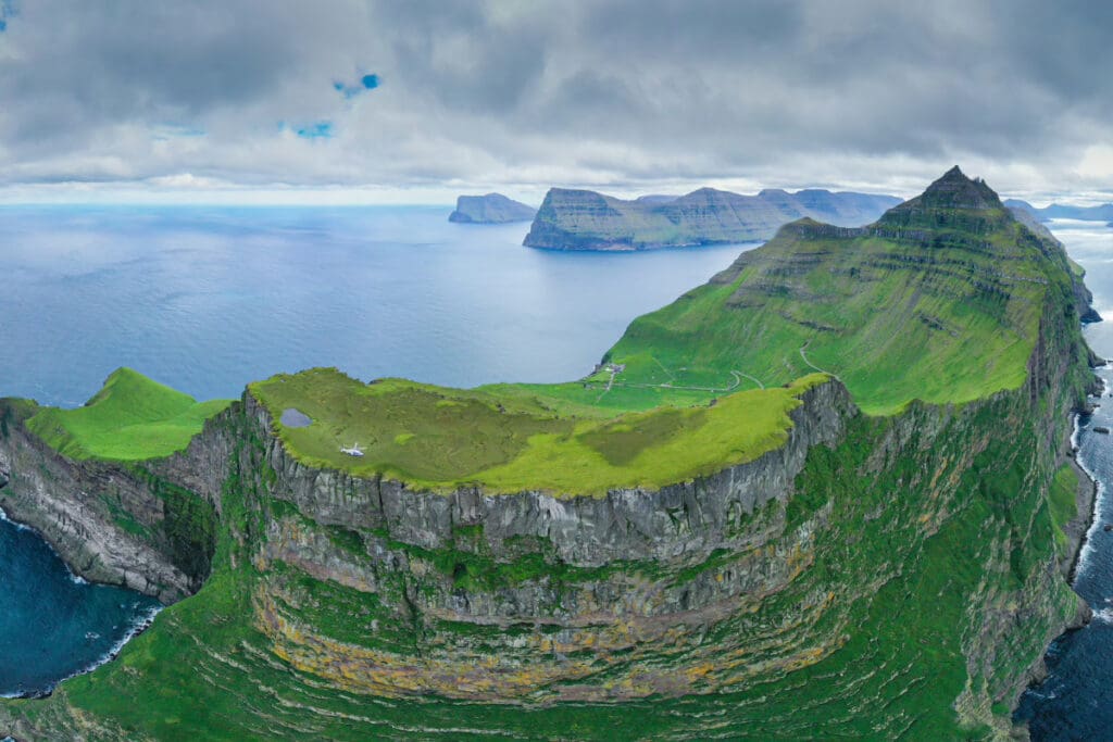 Aerial view of Kalsoy Island showcasing its cliffs and green landscape in the Faroe Islands.